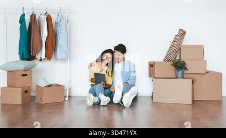 Couple Enjoying Time Together While Unpacking in Their New Home Stock Photo