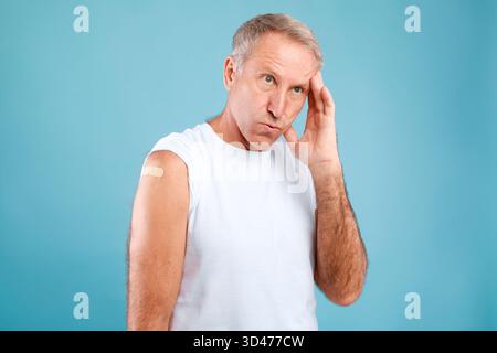 Vaccinated Adult Man Experiences Headache and Weakness After COVID-19 Vaccine Stock Photo