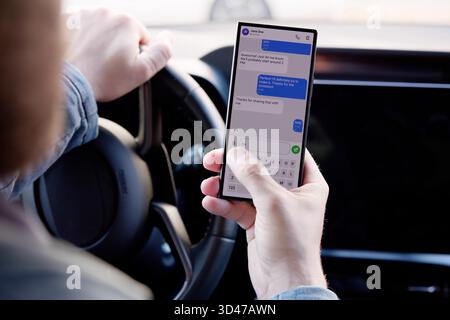 Multitasking Mechanic Checking Phone During Car Repairs, Fixing, Auto, Mechanic Stock Photo