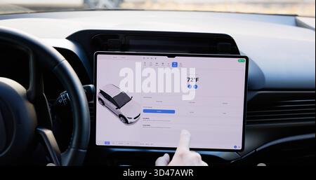 Young Male Using A Smart Touch Screen Dashboard. Stock Photo