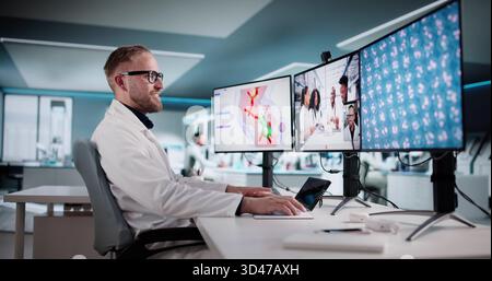 Collaborating Scientists In Lab Conduct Virtual Conference Using Innovative Technology Stock Photo