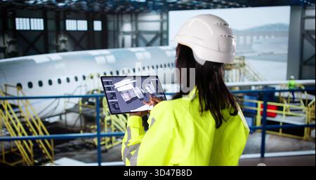 Inspecting Aviation Manufacturing Quality With African American Aerospace Engineer Woman Stock Photo