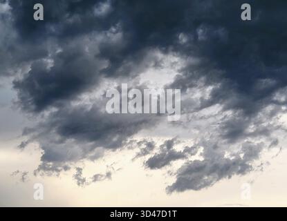 Dramatic and Majestic Gray and Black Clouds Spreading Across the Sky Before the Approaching Storm Stock Photo