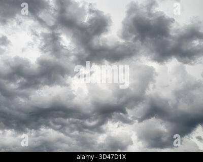 Dramatic and Majestic Gray and Black Clouds Spreading Across the Sky Before the Approaching Storm Stock Photo