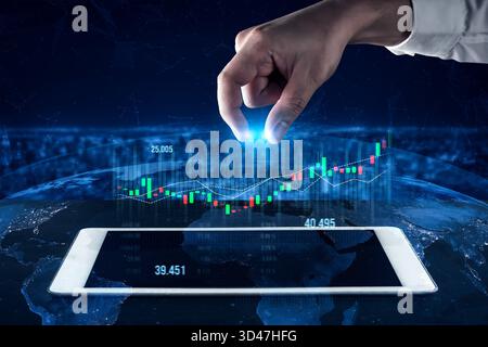 A human hand reaches for a glowing light above a digital screen displaying financial graphs over a global map, symbolizing technology and successful Stock Photo