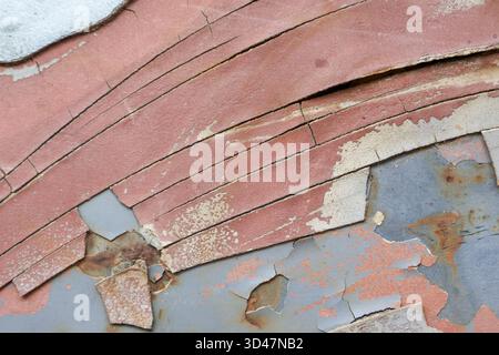 Peeling paint texture creates an abstract background. grunge, weathered surface on rusty metal shows layers of decay and damage, feeling old and aband Stock Photo