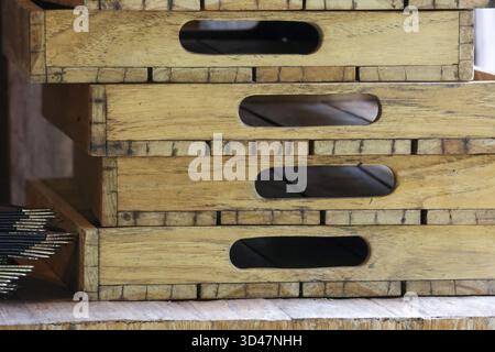 Rustic stack of empty wooden crate with handle in warehouse. This wood box shows detail, texture, and pattern, great for storage or transport backgrou Stock Photo