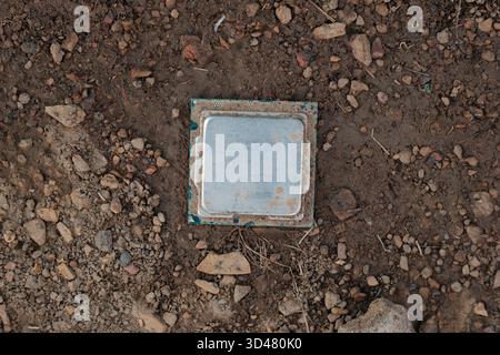 Discarded computer processor lying on soil Stock Photo