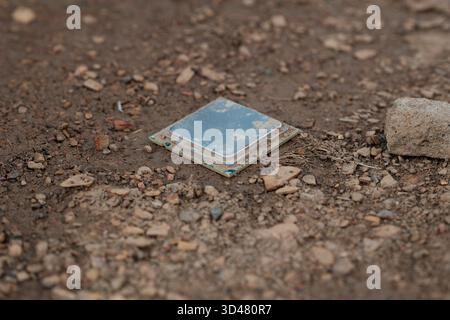 Discarded computer processor lying on soil Stock Photo