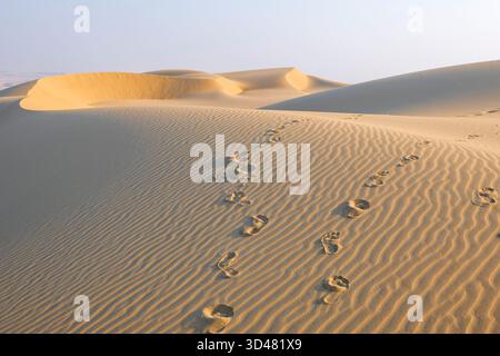 Doha, Qatar - October 30, 2025: Footprints on a desert dune Sealine beach Doha Qatar Stock Photo
