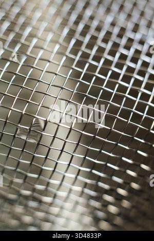 Close up of a stainless steel mesh for background or texture use. Stock Photo