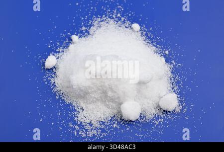 Thiourea powder on blue background Stock Photo