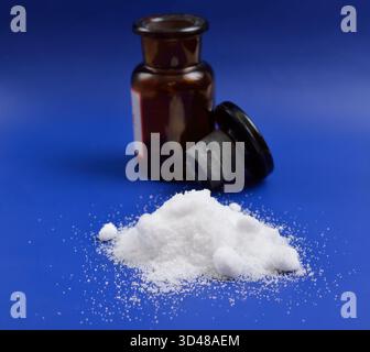 Thiourea powder on blue background Stock Photo