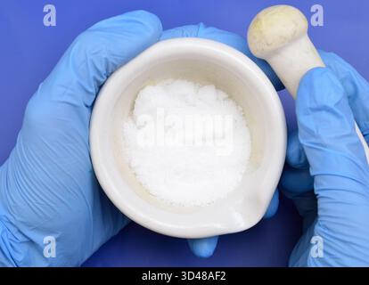 Thiourea powder on blue background Stock Photo