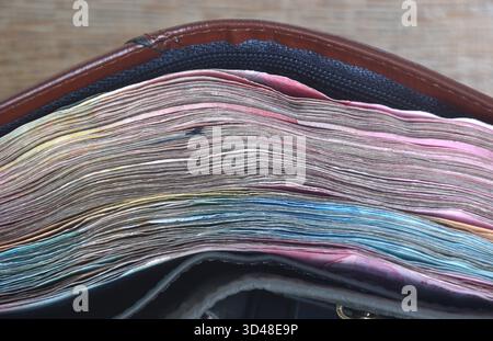 indonesia rupiah banknote in brown wallet on  wooden table texture and background Stock Photo