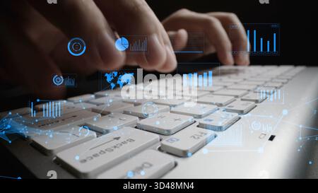 A close-up view of hands typing on a laptop keyboard, with vibrant data visualizations and graphs overlaid, symbolizing technology, data analysis, and Stock Photo