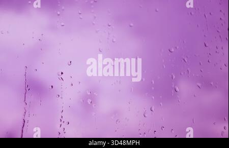 Pop art surreal style of light purple raindrops on window glass Stock Photo