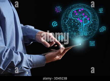 Man interacting with a digital tablet, demonstrating the concept of artificial intelligence, machine learning, and global technology Stock Photo