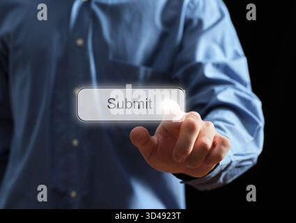 Person's hand interacting with a glowing submit button on a transparent screen, representing online action and digital submission Stock Photo