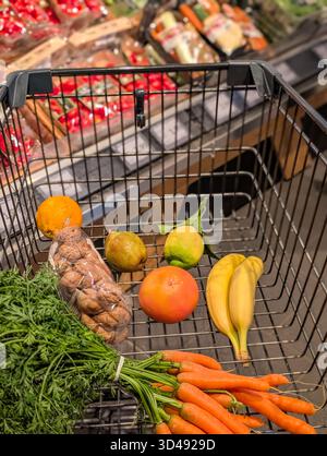 Shopping Cart In A Supermarket Filled With Fresh Fruit And Vegetables For A Healthy Diet Stock Photo