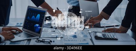 A dynamic business team collaborates in a modern workspace, utilizing technology and data visualization to enhance insights and drive strategic Stock Photo