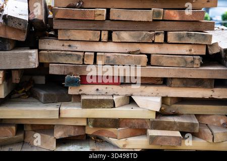 Close-up of stacked wooden boards nearly filling the frame. Ideal for use as a timber, wood, or construction background texture. Stock Photo