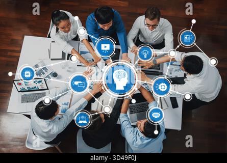 A dynamic teamwork scene showcasing professionals collaborating in a modern office, emphasizing the integration of technology and artificial Stock Photo