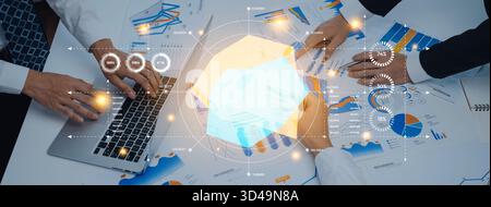 A professional workspace illustrates a collaborative business meeting, showcasing digital charts and data analysis for strategic planning and informed Stock Photo