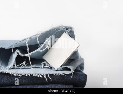 Blue denim jeans with fringe and label with space for text on a white background Stock Photo
