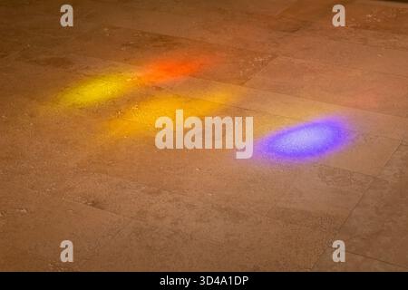 Vibrant colored light reflecting on a textured stone tile floor in Tuscany Stock Photo