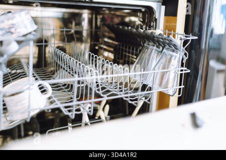 Dirty dishes, shelf for cups glasses in dishwasher Stock Photo