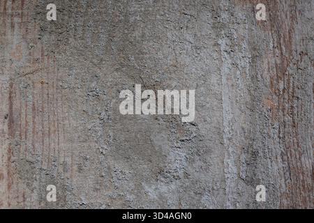 Old wooden plank wall showing weathered gray concrete texture, creating background with rough surfaces, cracks, and grunge patterns Stock Photo