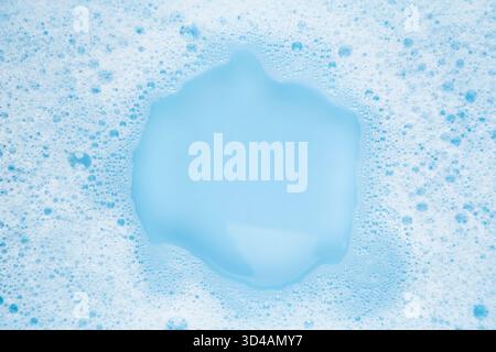 white soapy water on a blue background. Stock Photo