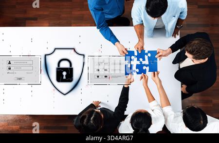 A team of professionals collaborates on digital security solutions, interacting with puzzle pieces and a lock icon, symbolizing the importance of data Stock Photo