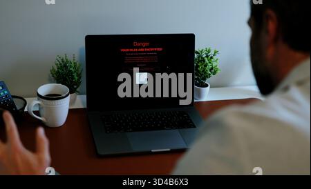 Middle Aged Executive Man Working From Home Falls Victim to Spear Phishing Ransomware Attack - Common Cybersecurity Scenario Concept Stock Photo