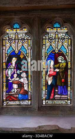 Victorian stained glass window in Winchester Cathedral, showing biblical figures in richly coloured Gothic panels commemorating Isabelle Jane Walford Stock Photo