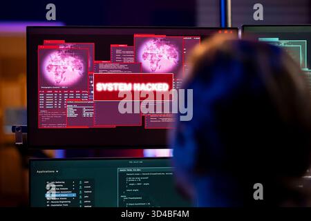 Close up of hacker looking at system hacked popup on screen after using AI malware software. Rogue programmer in underground hideout trying to hide online activity after stealing data Stock Photo