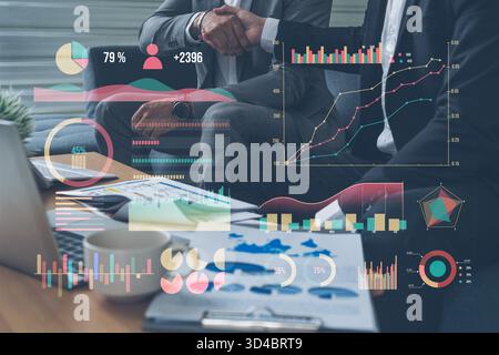 A business partnership is symbolized by a handshake, with dynamic digital data visualizations displaying financial graphs and analytics for strategic Stock Photo