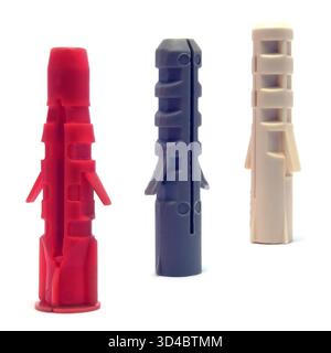 Plastic dowels colorful red ivory white, dark blue grey wall plugs, hollow nylon anchors large detailed isolated macro closeup, blank empty copy space Stock Photo