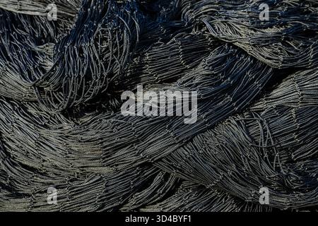 Closeup abstract pattern of detail in black industrial commercial fishing net Stock Photo