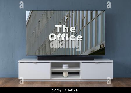 A widescreen OLED television showing the intro scene to the TV series The Office (UK), seen in a contemporary living room. Stock Photo