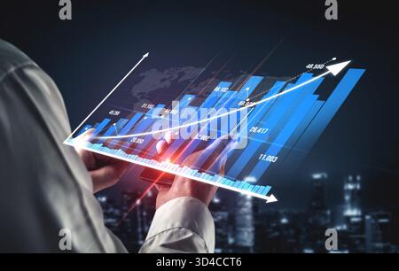 Business professional engages with a digital tablet, analyzing financial growth data displayed through interactive charts and graphs, showcasing Stock Photo