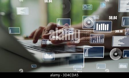 Hands typing on a laptop while surrounded by floating digital graphs and statistics, showcasing the integration of technology and data analysis in a Stock Photo