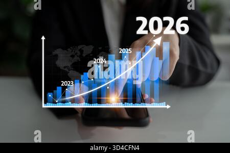 This image represents a business growth strategy with a smartphone displaying a graph. It forecasts data trends from 2023 to 2026, emphasizing success Stock Photo