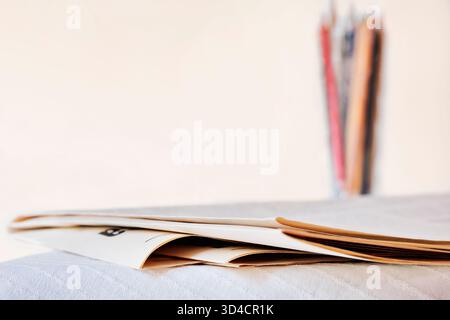 Folded newspapers on table , leisure time or professional occupation , Stock Photo