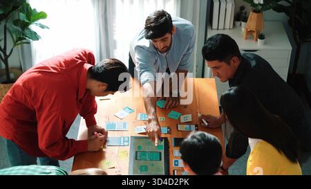 Front-end developer team brainstorming about Ux and Ui design for mobile app while designing application framework. Top down view of smart people Stock Photo