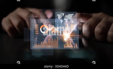 A close-up view of hands interacting with a futuristic interface, displaying various financial data and analytical graphs suitable for modern business Stock Photo