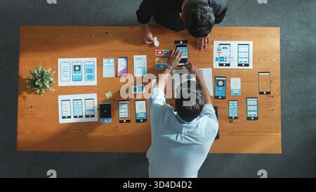 Top view of software developer working on Ux Ui design while team working together to brainstorm and develop wireframe prototype designing at creative Stock Photo