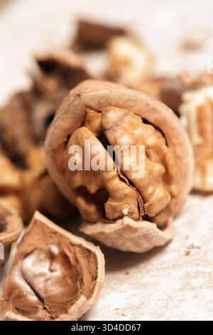 Whole and cracked walnuts and nutcracker Stock Photo
