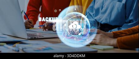 A diverse team of professionals collaborates on a cloud computing project, focusing on data backup and security with modern tools in a contemporary Stock Photo
